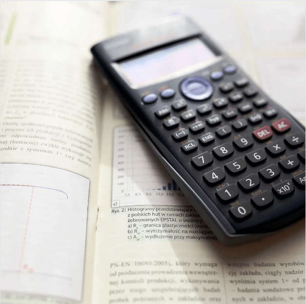 Photo shows a scientific calculator placed on top of a book.
