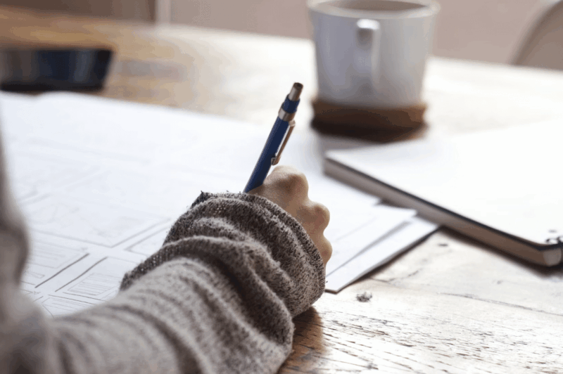 student taking exam with pencil
