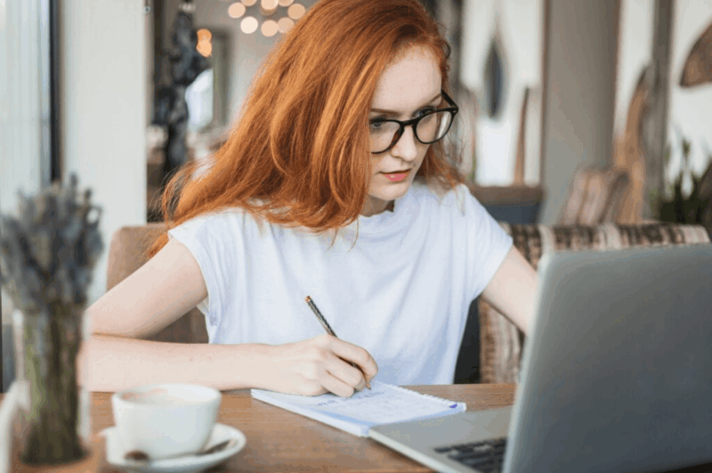 woman with glasses at computer