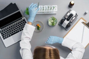 top view female researcher lab with laptop
